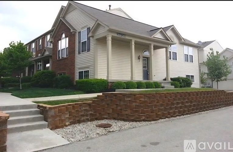 A house with a brick wall and a porch.