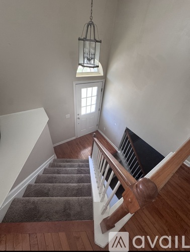 A staircase with a light hanging from the ceiling.