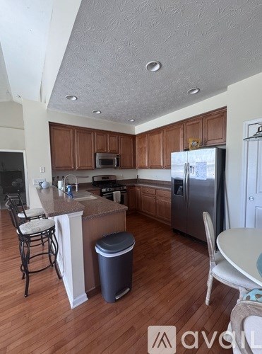 A kitchen with wooden cabinets and a white refrigerator.