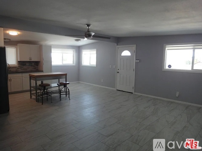 A kitchen with a table and chairs in the middle of the room.