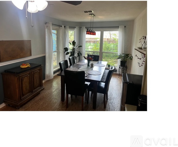 A dining room with a table set for six.