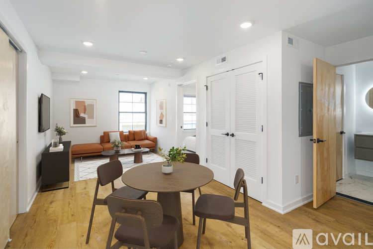 A modern living room with a brown table and chairs.