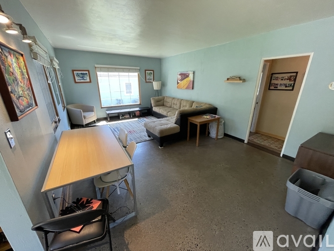 A living room with a couch, chair, and table.