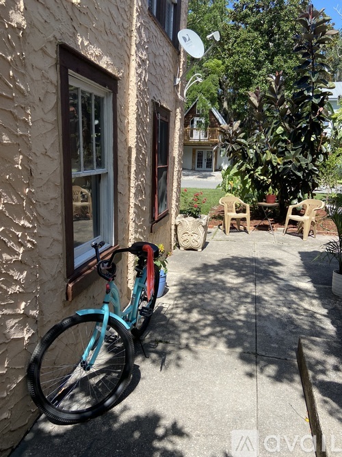 A bicycle is parked on a sidewalk next to a building.