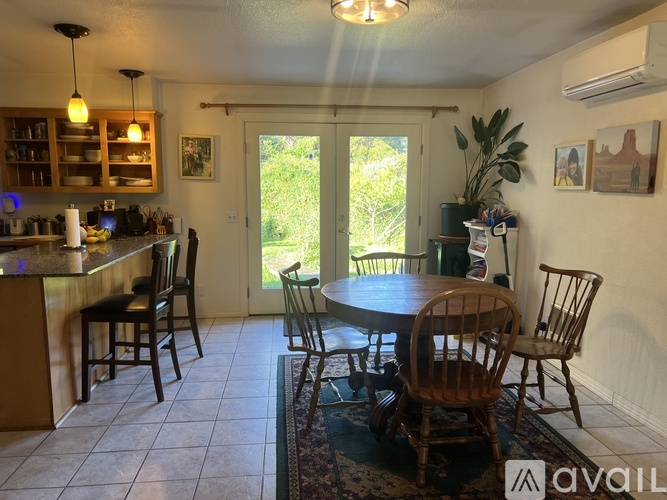 A kitchen with a dining table and chairs.