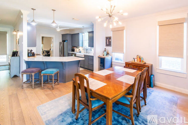 A dining room with a wooden table and chairs.