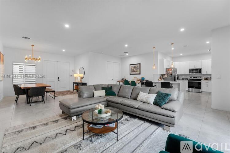 A modern living room with a grey sofa and a coffee table.