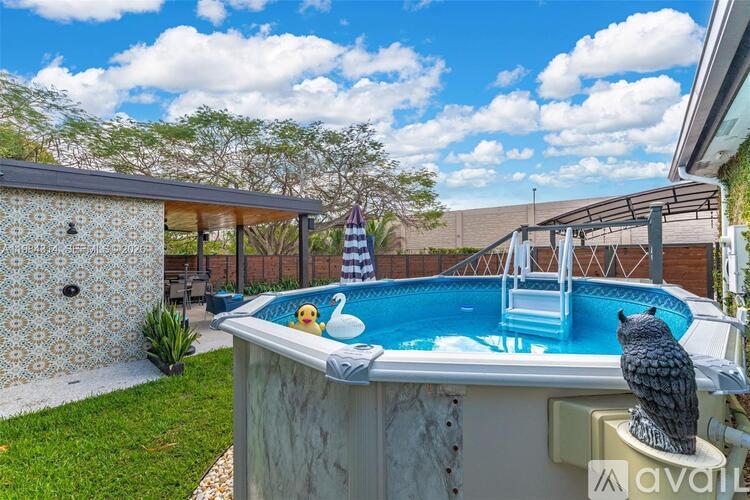 A small pool with a ladder and a statue of an owl.