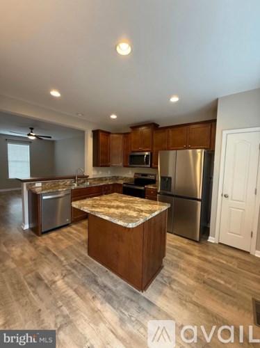 A kitchen with wooden cabinets and a central island.