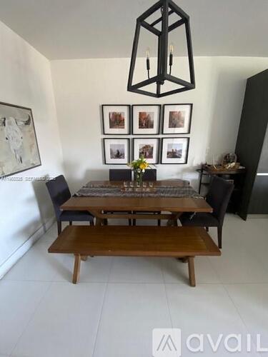 A dining room with a wooden table and chairs.