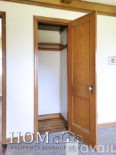 A brown door with a white wall behind it.