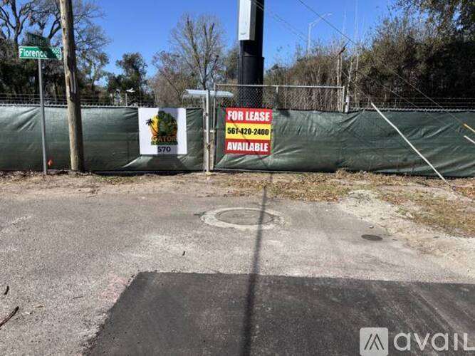 A for lease sign is posted on a fence.