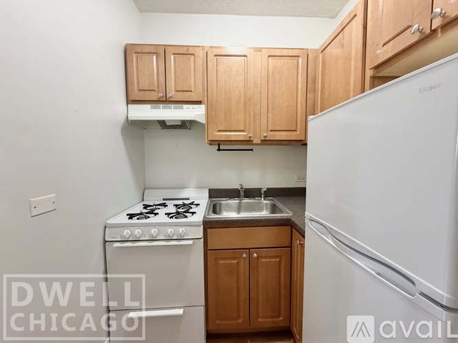 A kitchen with a white fridge, white stove and white oven.