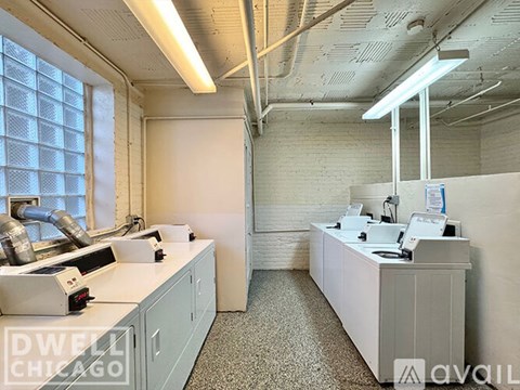 A white office space with a desk and a window.