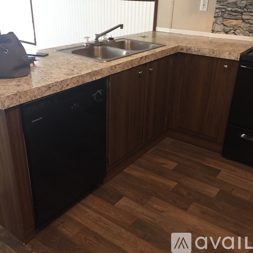 A kitchen with wooden cabinets and a granite countertop.