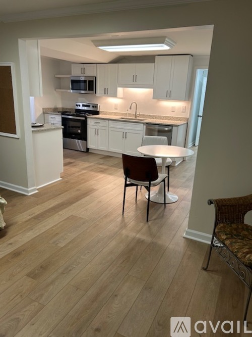 A kitchen with a table and chairs in the middle of the room.