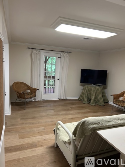A living room with a white couch and a television.