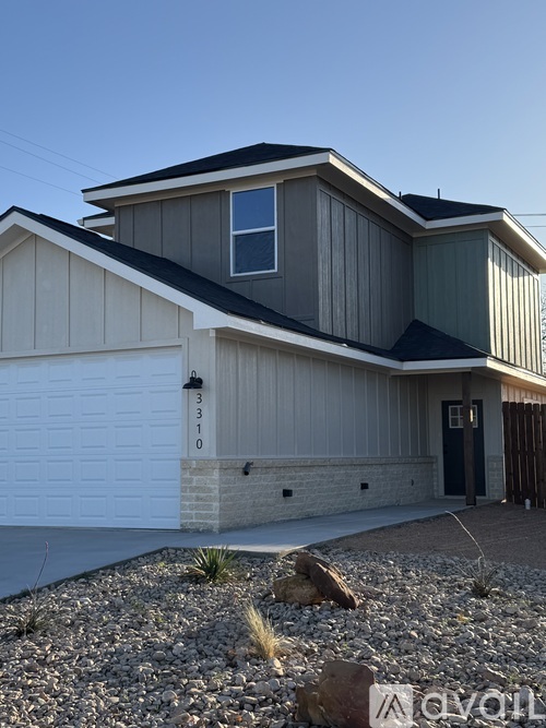A modern house with a garage and a driveway.