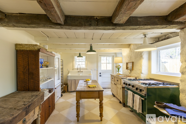 A kitchen with wooden cabinets and a checkered floor.