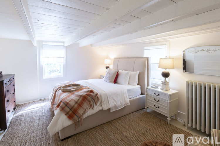 A bedroom with a large bed and a window.