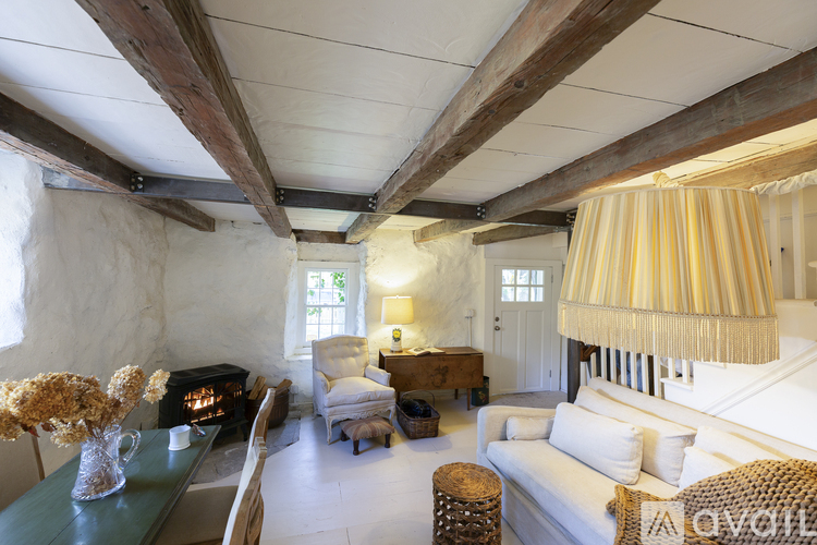 A well-lit, spacious room with a fireplace and a large bed.