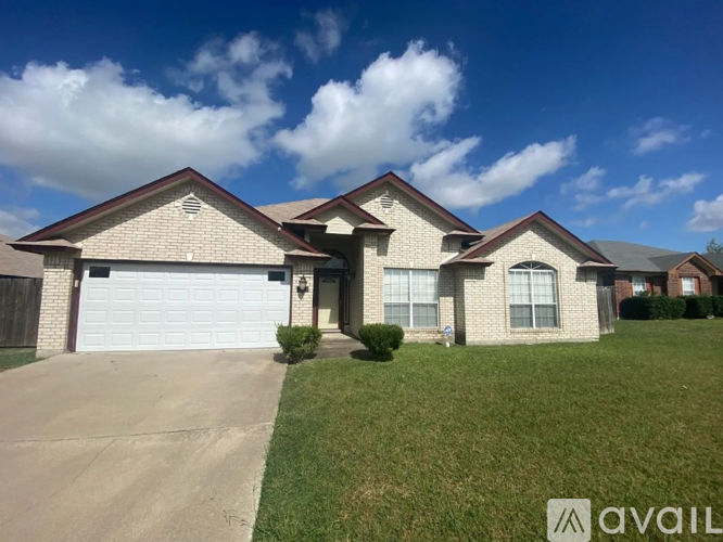 A house with a garage and a driveway is for sale.
