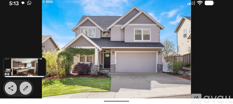 A house with a grey roof and a white garage door.