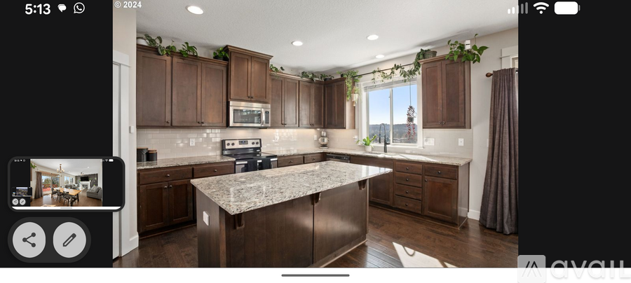 A modern kitchen with dark wood cabinets and a central island.