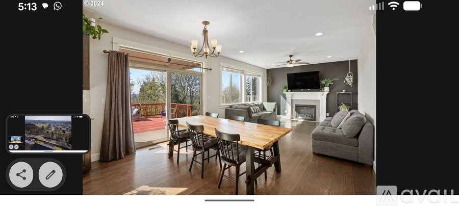A modern dining room with a wooden table and chairs.