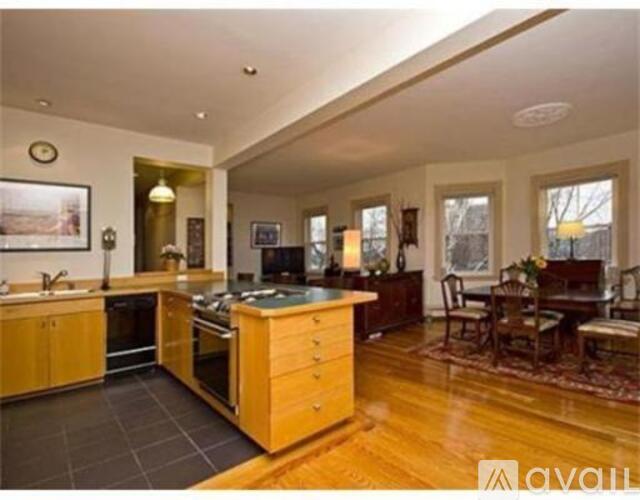 A kitchen with wooden cabinets and a large island.