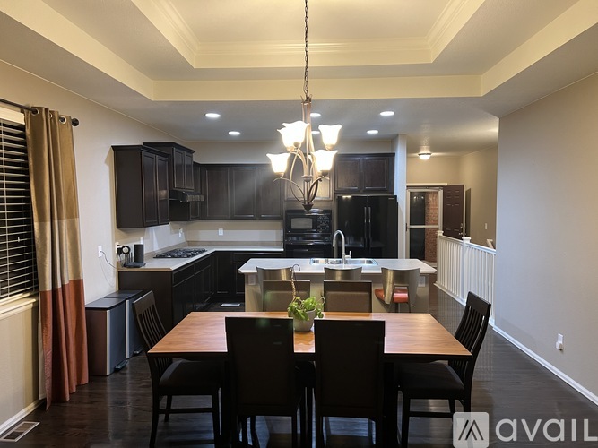 A modern kitchen with dark wood cabinets and a center island.