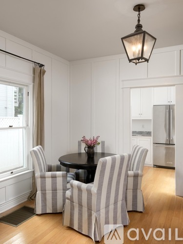 A dining room with a table and chairs.