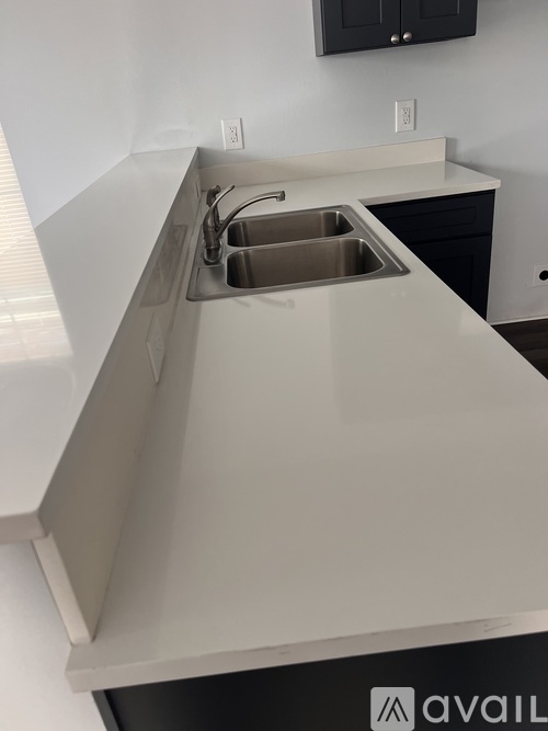 A kitchen with a sink and a cabinet.