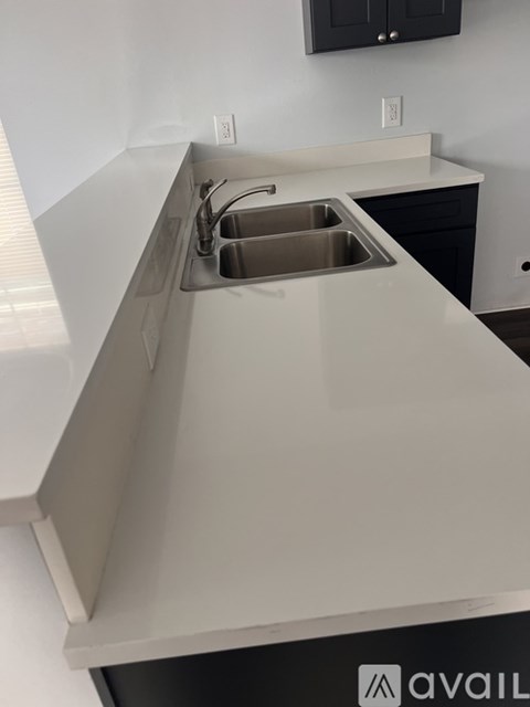 A kitchen with a sink and a cabinet.