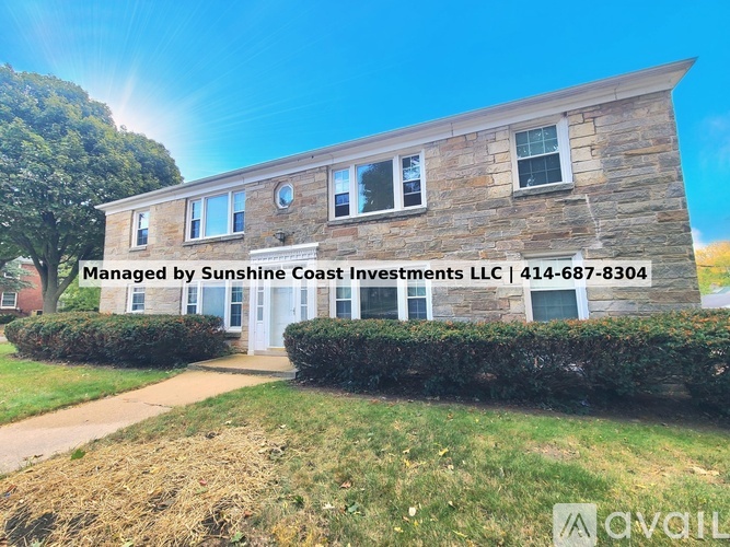 A building with the text "Managed by Sunshine Coast Investments LLC | 414-687-8304" on it.