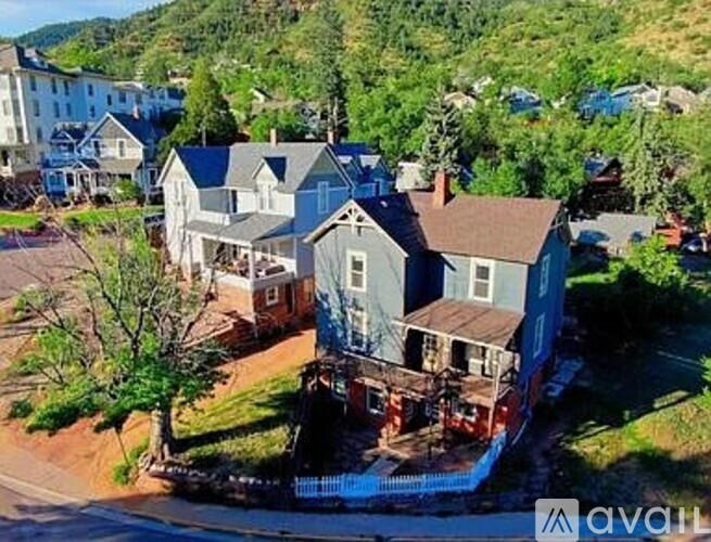 A house with a blue roof is for sale.