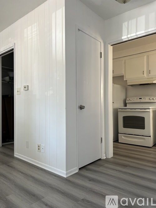 A kitchen with a white fridge, stove and cabinets with a sign that says "let's eat".