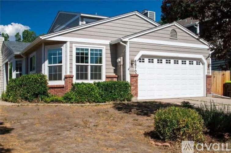 A house with a white garage door is for sale.