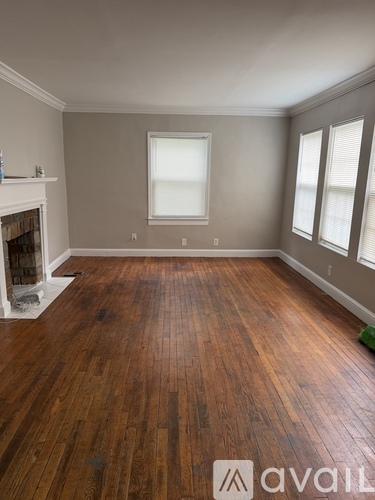 A room with wooden floors and a fireplace.