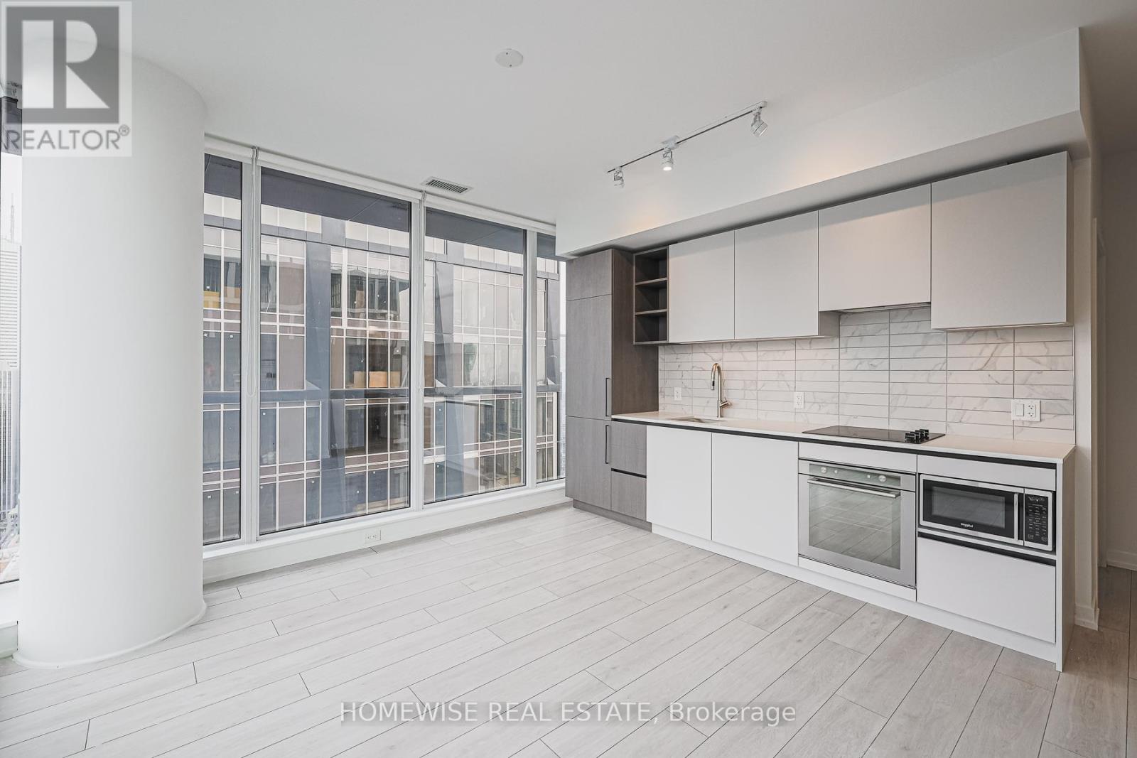 A modern kitchen with white cabinets and a large island.