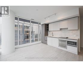 A modern kitchen with white cabinets and a large island.