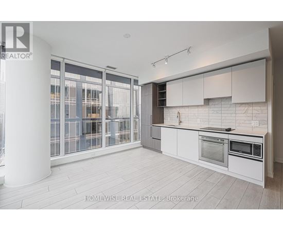 A modern kitchen with white cabinets and a large island.