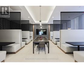 A modern dining room with a long table and chairs.