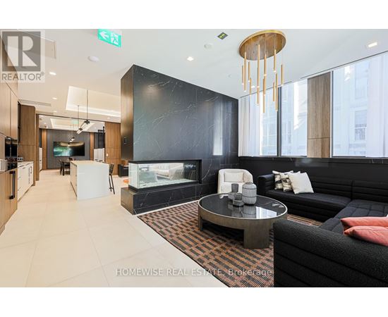 A modern living room with a black couch and a coffee table.