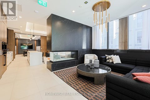 A modern living room with a black couch and a coffee table.
