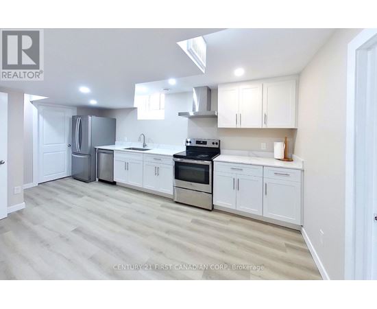 A clean, modern kitchen with white cabinets and stainless steel appliances.