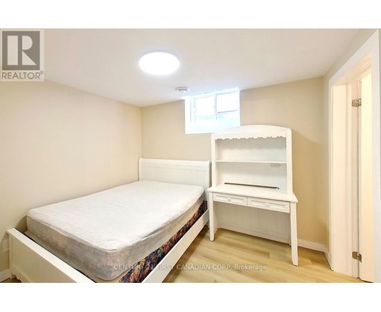 A bedroom with a bed and a desk.