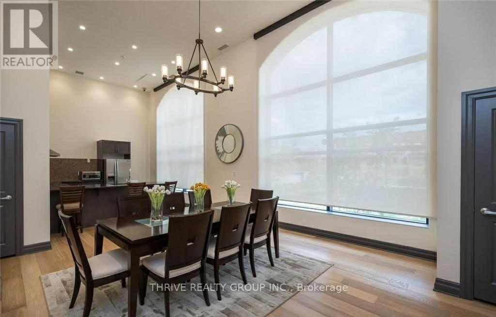 A dining room with a table set for six.