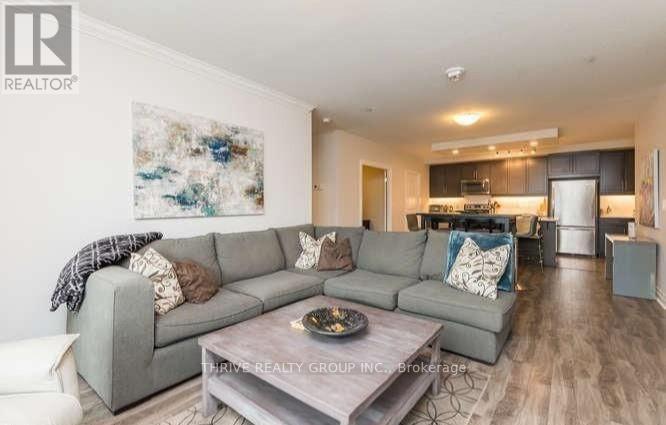 A modern living room with a grey sofa and a coffee table.