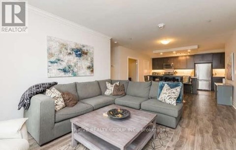 A modern living room with a grey sofa and a coffee table.